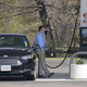 A customer fuels his car at a Mobil gas station in Massachusetts.